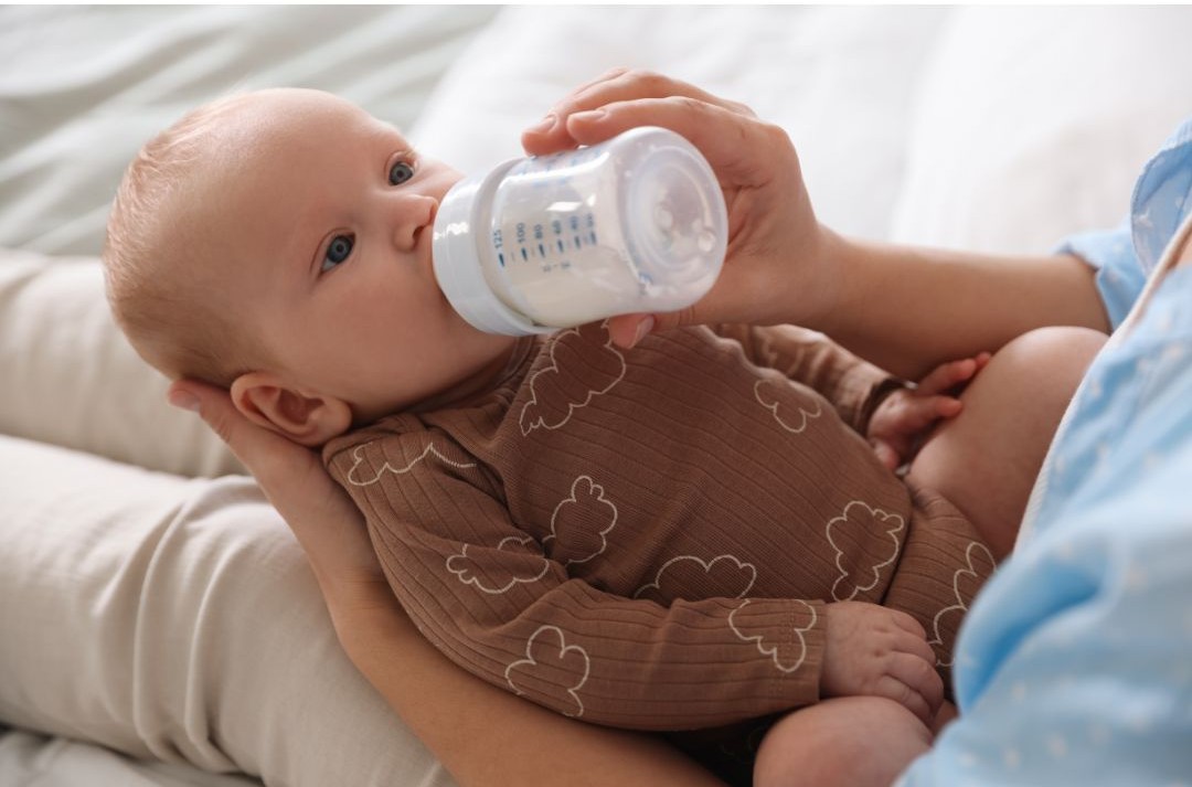 Baby taking a bottle of milk